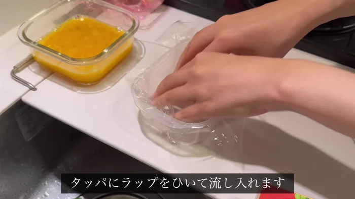 Pour the egg mixture into a Tupperware container covered with plastic wrap. Microwave for 1 minute, stir lightly, then microwave for another 1.5 minutes.