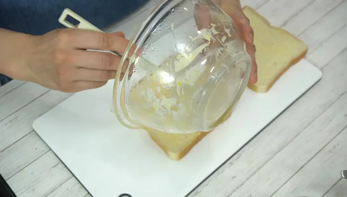 Assemble sandwich: Spread egg filling evenly onto one slice of bread. Top with the other slice. Wrap tightly in plastic wrap and let sit for 5 minutes.