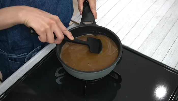 Cook the mixture over medium heat, stirring constantly with a rubber spatula. The mixture will gradually thicken and harden; peel off the hardened parts as you stir.