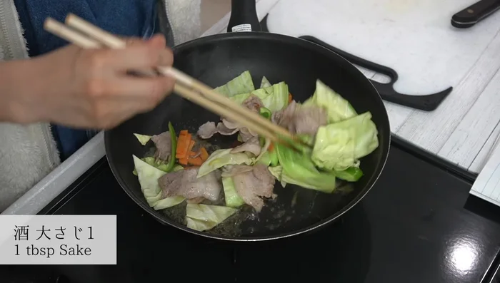 Pour sake over the vegetables, stir, cover and steam for 1 minute.