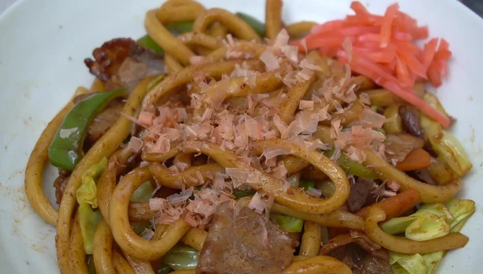 Serve and garnish with bonito flakes and red ginger.