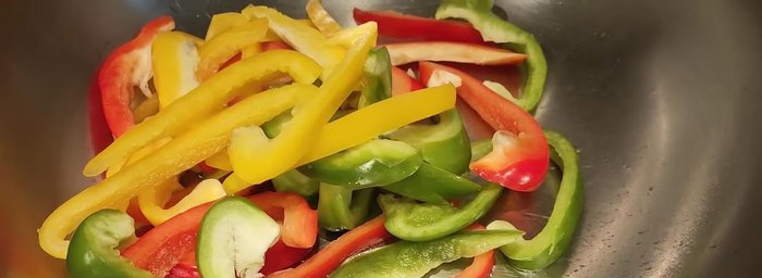 Pour the prepared seasoning over the ingredients in the wok and stir to coat everything evenly.