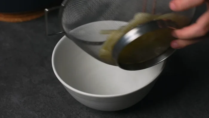Place cooked udon noodles in a bowl.