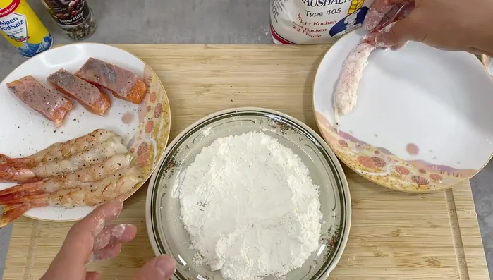 Coat shrimp and salmon with flour, then dip in beaten egg, and finally coat with panko breadcrumbs.