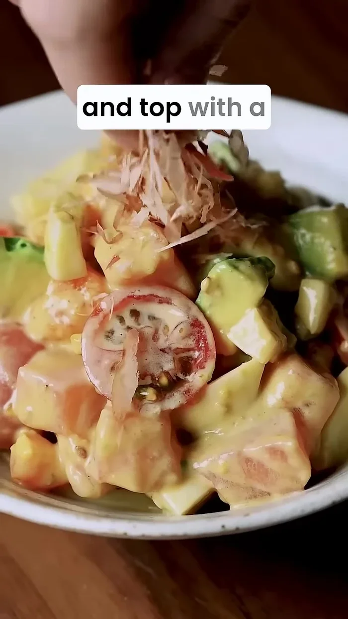 Divide the salad into serving bowls. Top with bonita flakes and chopped green onions.
