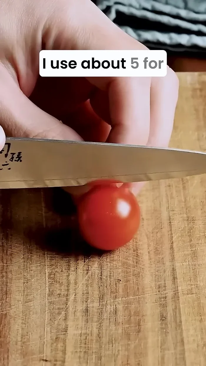 Add mini tomatoes to the bowl.