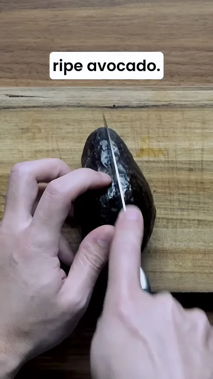 Add the flesh of one ripe avocado to the bowl.