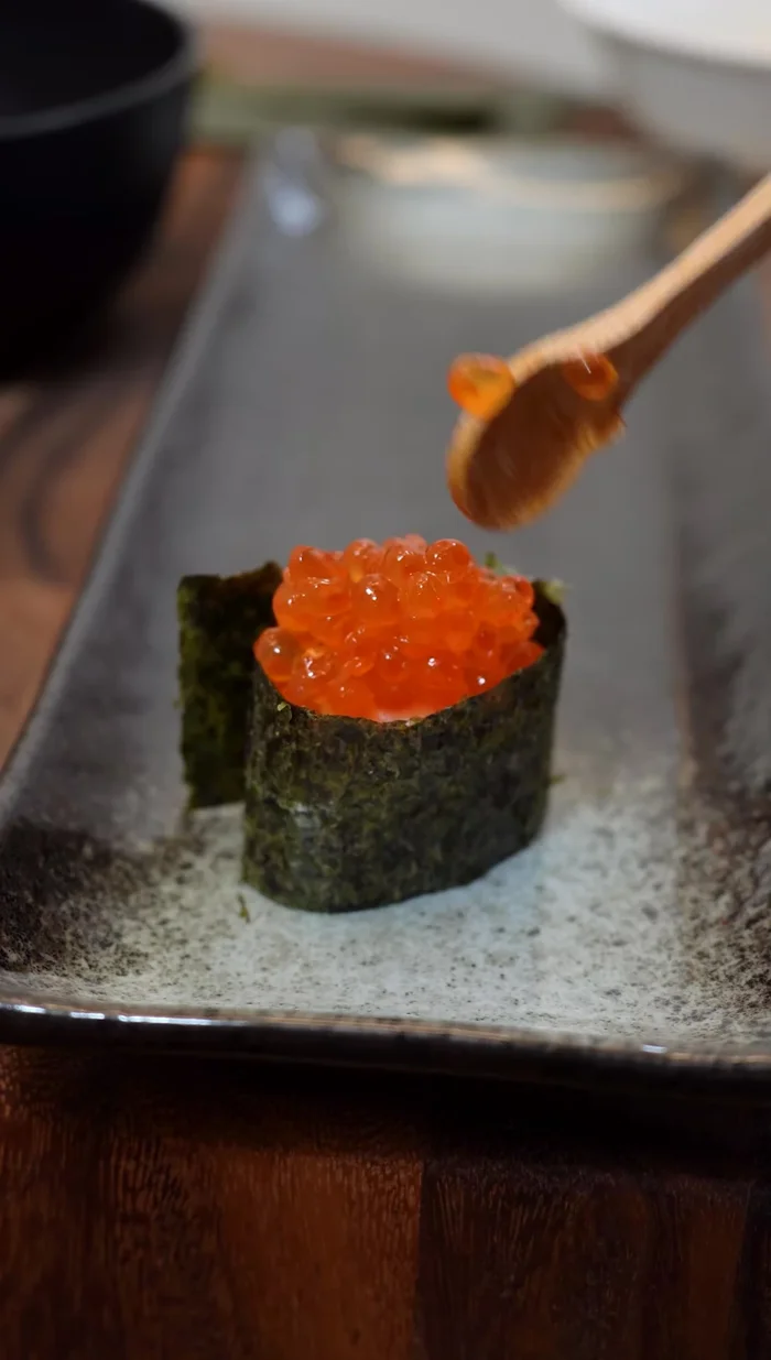 Add the Ikura: Top the rice with a generous portion of salmon roe (Ikura).