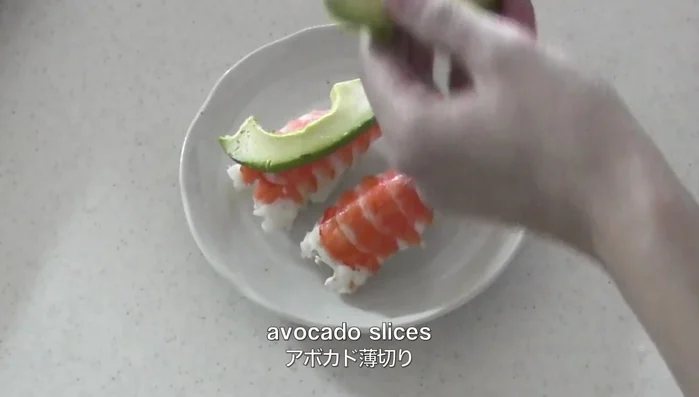 Add avocado and onion (optional): Make into a desired shape and add on top of the shrimp sushi (160.03).