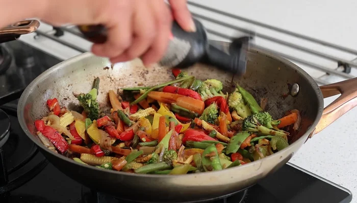 Make noodles: Add vinegar, soy sauce, salt, chili flakes, bean sprouts, and noodles to sautéed vegetables.