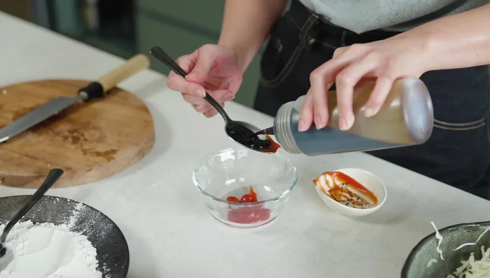 Make the katsu sauce by mixing tomato sauce, soy sauce, Worcestershire sauce, sugar, and water.