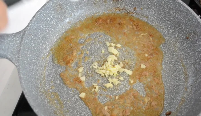 Transfer the cooked hamburger steak to a small cast iron skillet or dish.