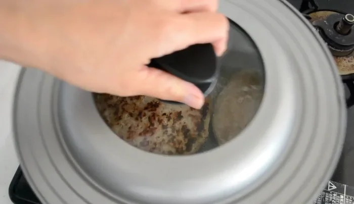 Check doneness by pushing with a spatula; it should bounce back if ready. Alternatively, insert a toothpick; translucent juice indicates it's cooked through.