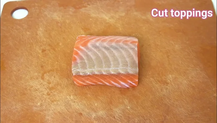 Carefully remove the oshizushi from the mold, and slice into bite sized pieces.