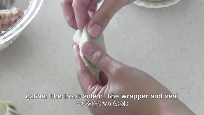 Put water along the edge of the wrapper, fold into a semicircle, and seal.