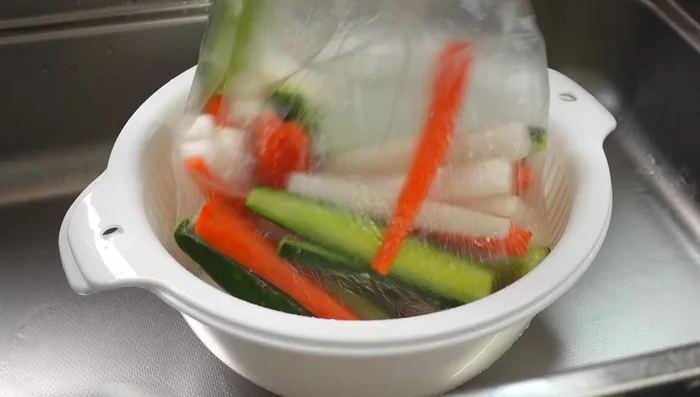 Drain excess water from the salted vegetables by squeezing them. Do not rinse. [235.4]