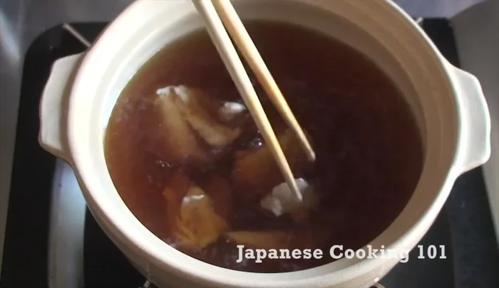 Add udon noodles to the broth.