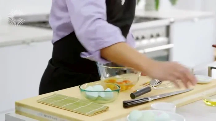 Prepare the tamagoyaki ingredients: whisk together eggs, water, mirin, light soy sauce. (195.049)