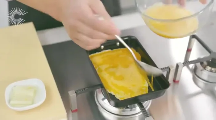 Gently roll the cooked egg, adding more egg mixture to create layers. Repeat until all the mixture is used. (241.77)