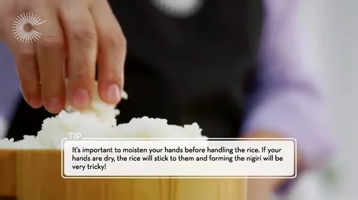 To assemble the nigiri, wet your hands, take a small amount of rice, shape it into an oval, and place a slice of tamagoyaki on top. (365.65)