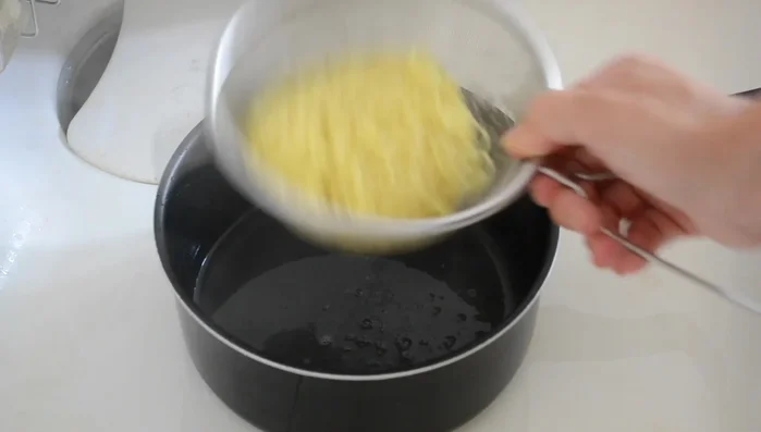 Transfer noodles to prepared bowls, mix well with the sauce.