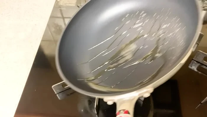 Lightly fry the tofu pieces until crispy, ensuring even browning.