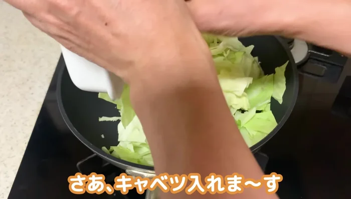 Add the cabbage to the hot pan and stir-fry until slightly softened and glistening, allowing the salt to draw out moisture.