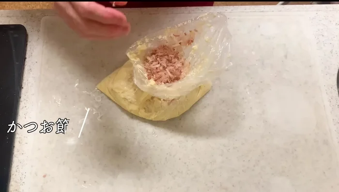 Add bonito flakes and chopped green onions to the mixture. Mix well.