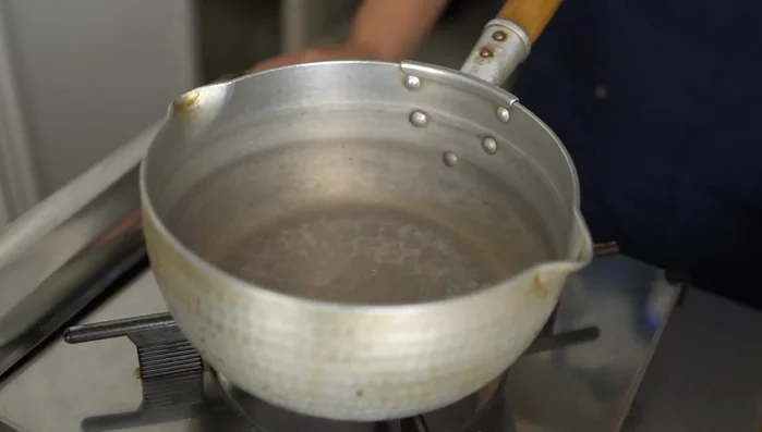 Heat the Yukihira pot, add oil, then onions. Stir-fry until softened.