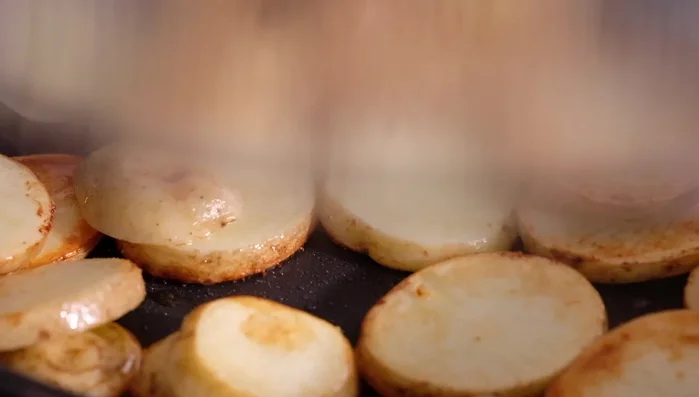 Steam the potatoes for a few more minutes after wiping the lid. They are ready when easily pierced with a fork.