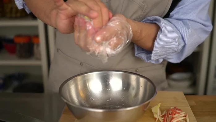 Discard the water released from the radish peels. Gently rub them in the bag to further remove moisture.