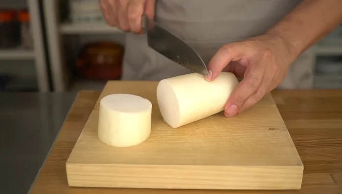 Cut the radish into triangles, following the fiber direction for a crispy texture. This method is efficient and creates a visually appealing shape.
