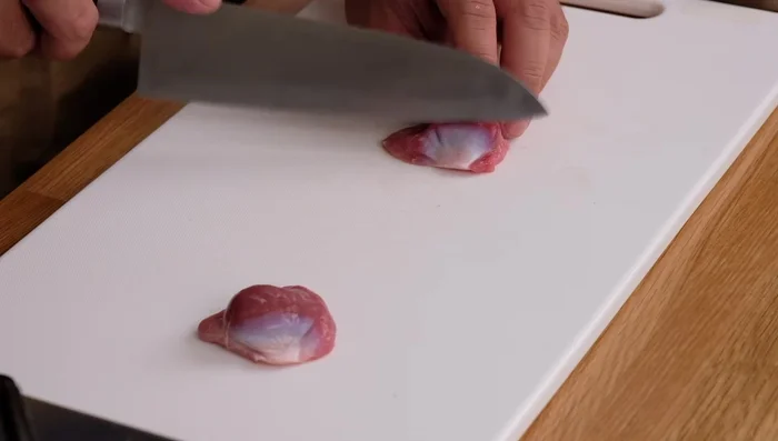 Kijima-style peeling: Make one cut slightly below the top of the 'mountain', then another on the opposite side. Pull the skin with your right hand. Use your left thumb to help peel the skin along the edge. Repeat on the other side.