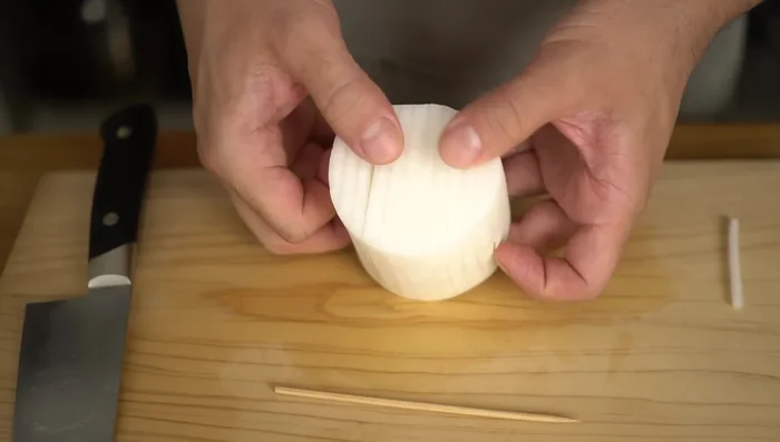 Rotate the radish 90 degrees so that the cut you just made is horizontal.