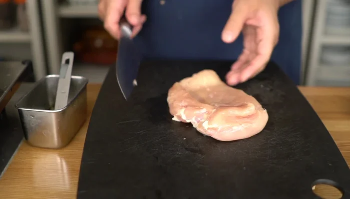 Peel and slice chicken breast thinly against the grain.