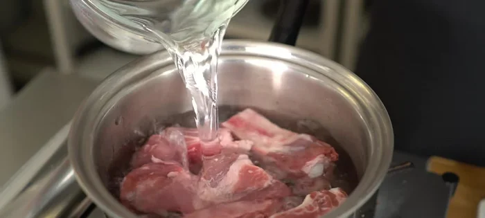 Place spare ribs in a pot and cover with water. Bring to a boil.