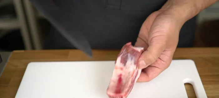 Prepare the spare ribs by making a cut in the membrane on top of the bone to make it easier to separate from the bone.