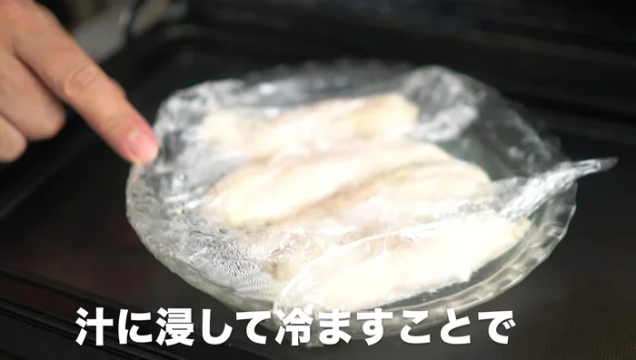 Let the chicken cool in the microwave with the plastic wrap on, still submerged in the liquid.
