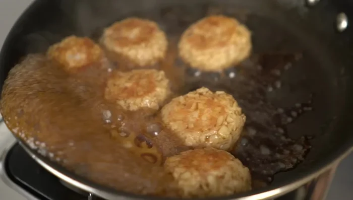 Increase the heat slightly, and simmer the meatballs in the sauce, stirring occasionally, until the sauce thickens slightly.