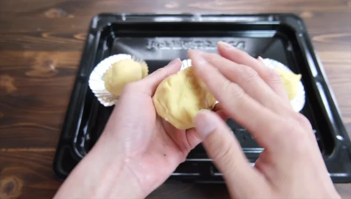 Roll each portion into a smooth, round ball using a gentle rolling and shaping technique.