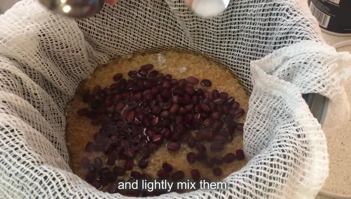 Season the rice. Add salt, the cooked adzuki beans, and optionally plum vinegar to the rice cooker. Mix gently.