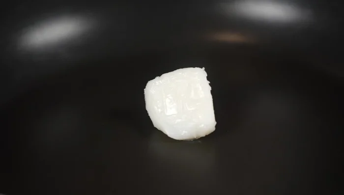 Make garlic chips: Fry thinly sliced garlic in beef tallow over low heat until crispy.