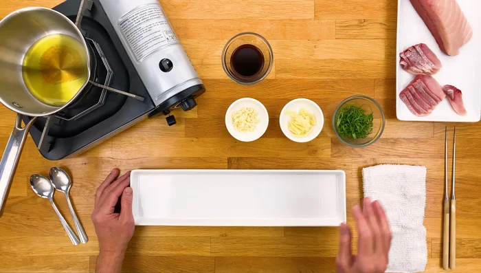 Arrange Hamachi slices evenly on a heat-safe plate.