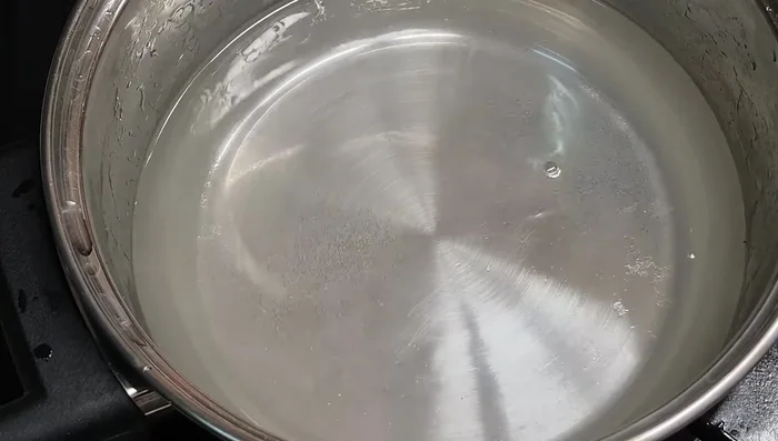 Add hot sauce to the vinegar mixture.