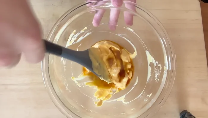 Add the rice vinegar, soy sauce, lemon juice, minced onion, and prepared cucumber to the mayonnaise mixture gradually, mixing well after each addition to prevent separation.