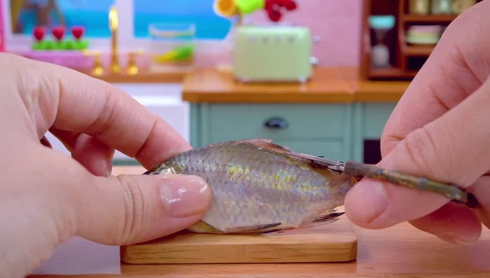 Clean and prepare the fish: remove scales, cut off tail, slice, salt, pepper, and turmeric.