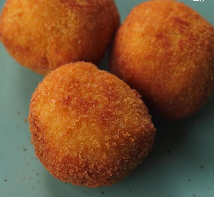 Fry the ice cream: Heat vegetable oil in a frying pan. Carefully place the coated ice cream balls into the hot oil and fry until golden brown and crispy.