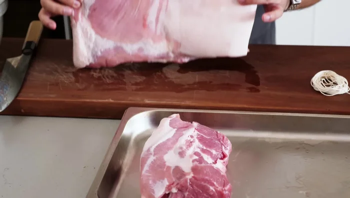 Prepare the pork belly: Cut a piece of pork belly in half, ensuring the grain runs along the length. Remove the skin.