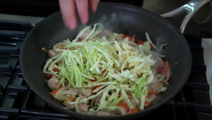 Add cabbage and cook for another minute. Season with salt and pepper.