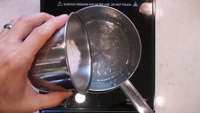 In a small pot, bring 450ml of water to a simmer. Add salt and stir until dissolved.